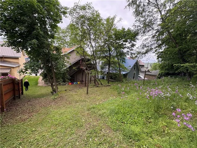 a view of a tree in front of a house