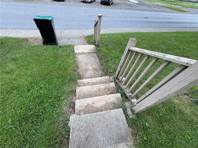 a view of a backyard with chairs