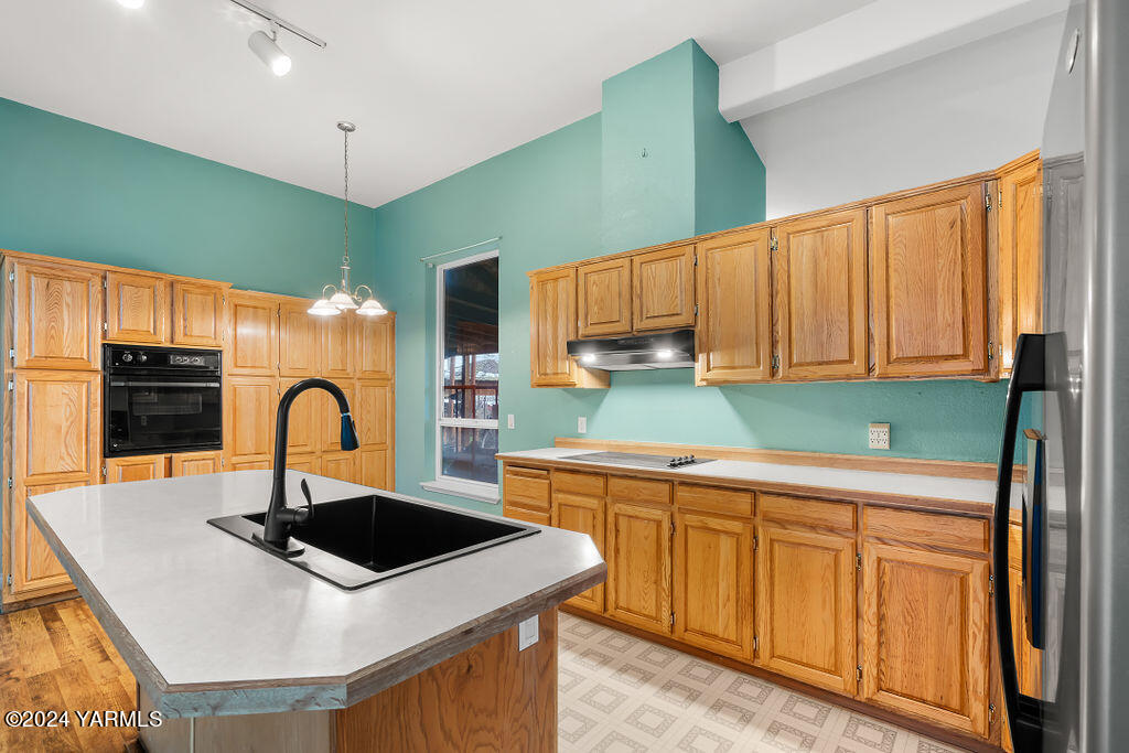 4111 Bell Road Yakima, WA 98901 - Photo 12 of 33 a kitchen with stainless steel appliances a sink a stove top oven a counter space and cabinets