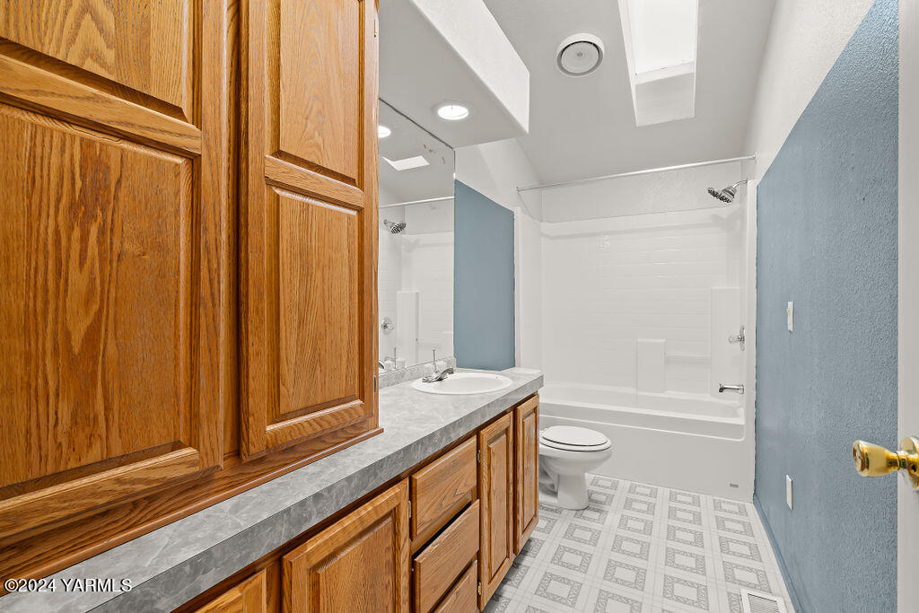 4111 Bell Road Yakima, WA 98901 - Photo 23 of 33 a bathroom with a granite countertop sink toilet and shower