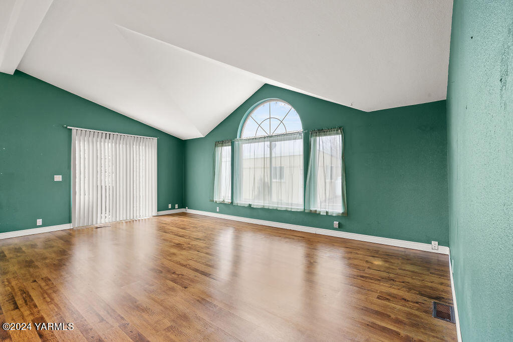 4111 Bell Road Yakima, WA 98901 - Photo 10 of 33 a view of an empty room with wooden floor and a window