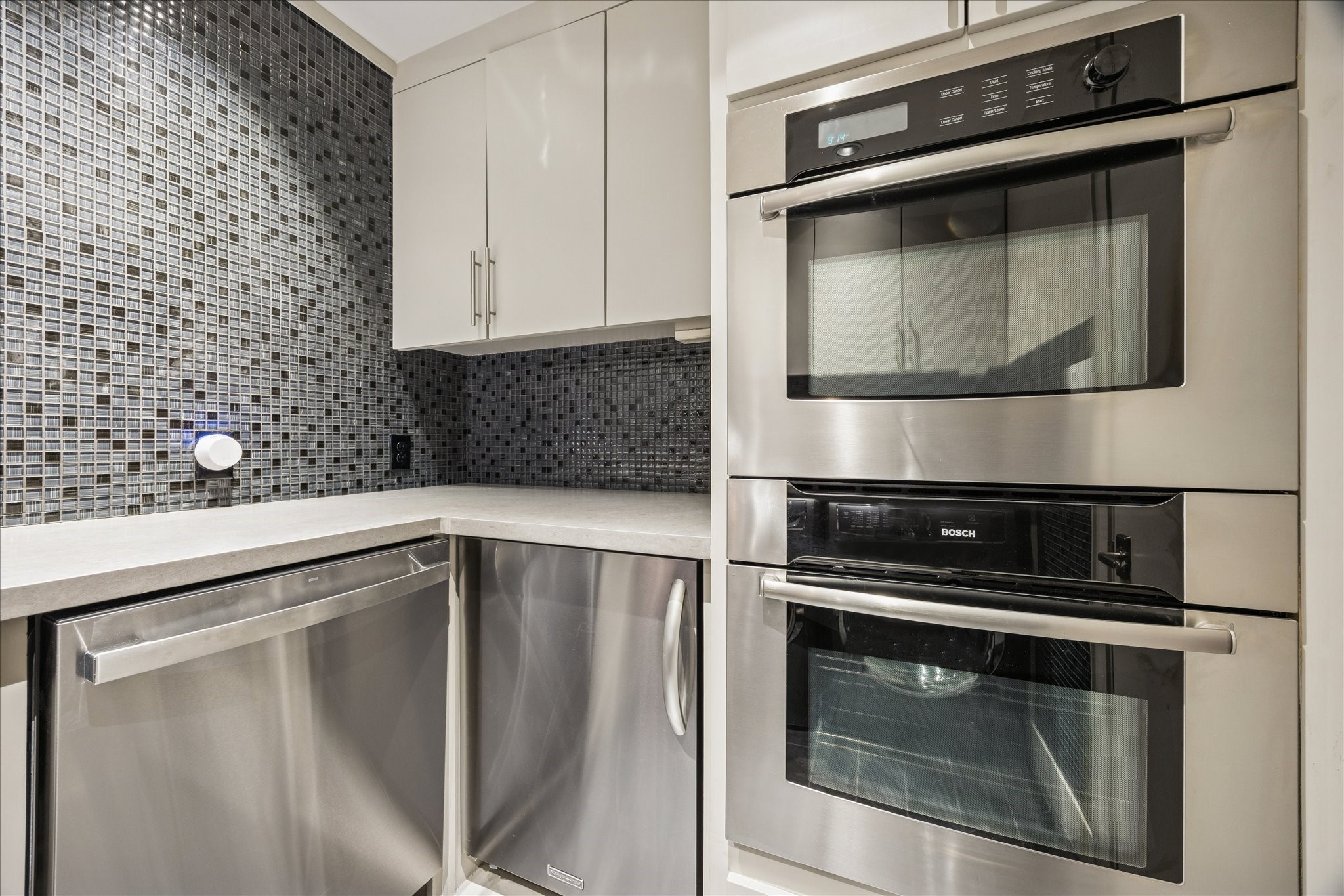 3124 Mid Lane Houston, TX 77027 - Photo 36 of 41 a kitchen with granite countertop white cabinets and stainless steel appliances