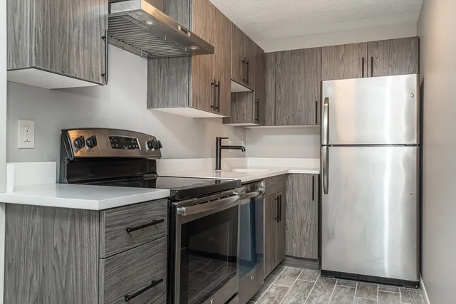 a kitchen with a stove and a refrigerator