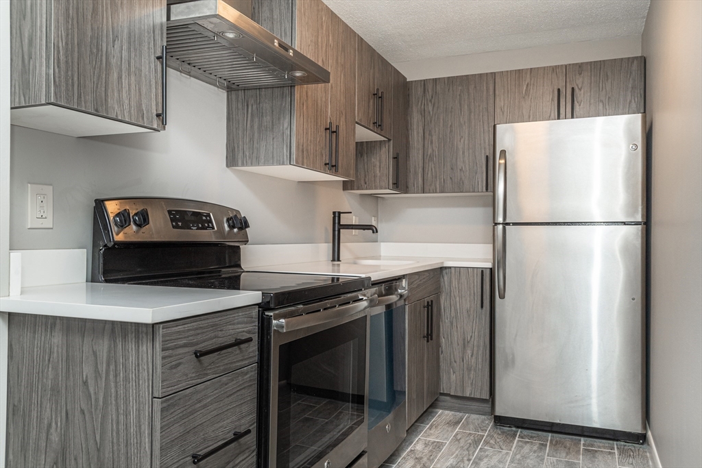 a kitchen with a stove and a refrigerator