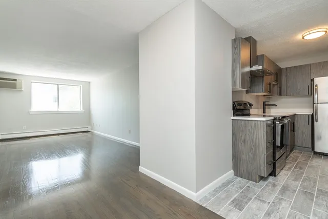 a view of a kitchen with a sink wooden floor and windows