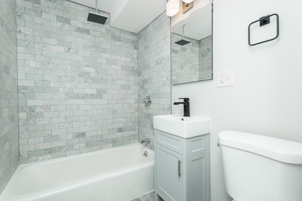 14 Murdock Street, Unit 28 Somerville, MA 02145 - Photo 6 of 14 a bathroom with a sink a toilet and shower