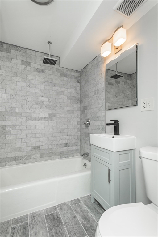 14 Murdock Street, Unit 28 Somerville, MA 02145 - Photo 7 of 14 a bathroom with a sink a toilet and shower