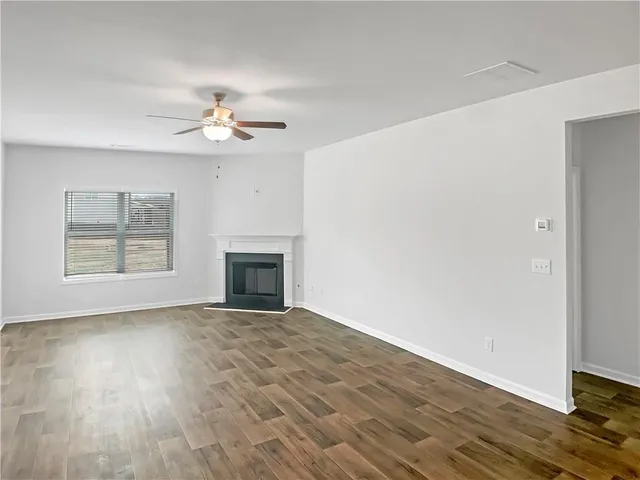 an empty room with windows and a fireplace