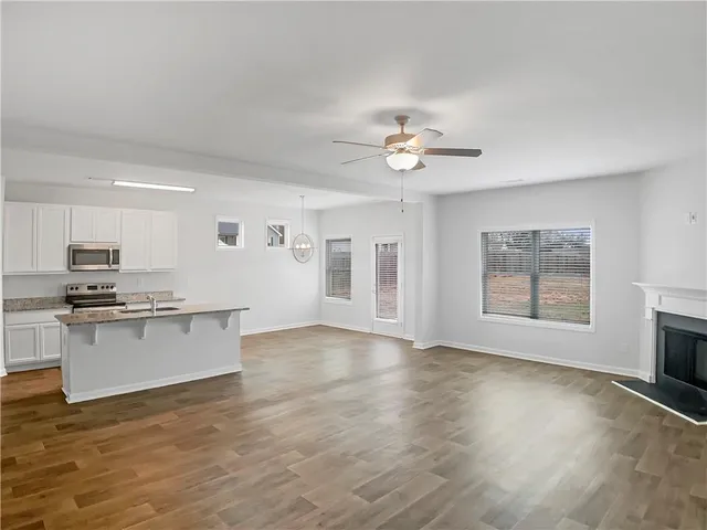 a view of kitchen with sink microwave and stove