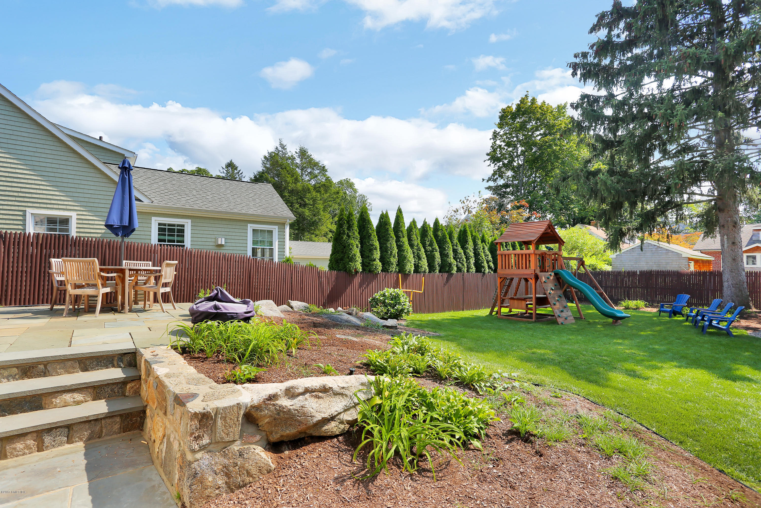 27 Pleasant Street Cos Cob, CT 06807 - Photo 17 of 21 a view of a garden with a slide and a tree