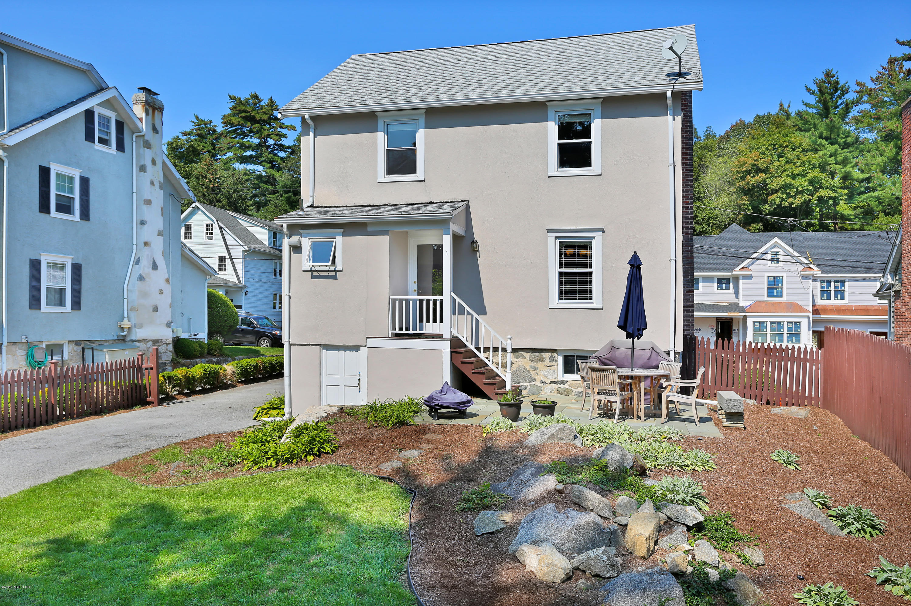 27 Pleasant Street Cos Cob, CT 06807 - Photo 19 of 21 a front view of a house with a yard