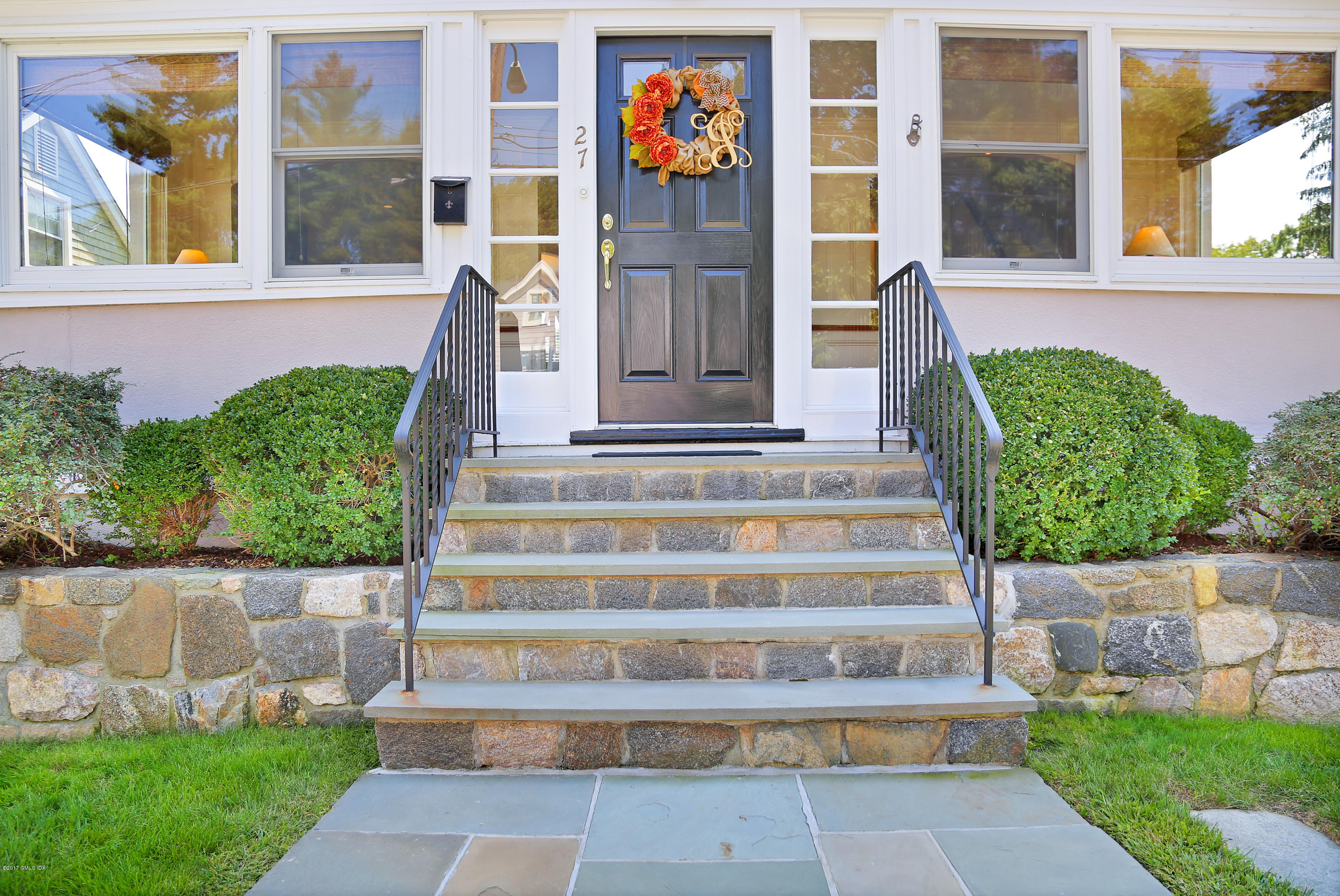 27 Pleasant Street Cos Cob, CT 06807 - Photo 2 of 21 a front view of a house with a garden