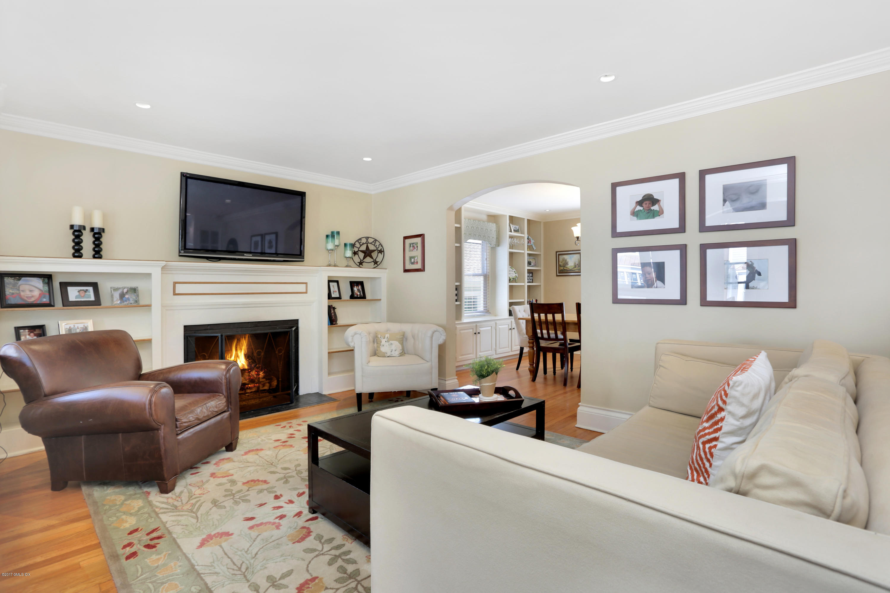 27 Pleasant Street Cos Cob, CT 06807 - Photo 5 of 21 a living room with furniture a flat screen tv and a fireplace
