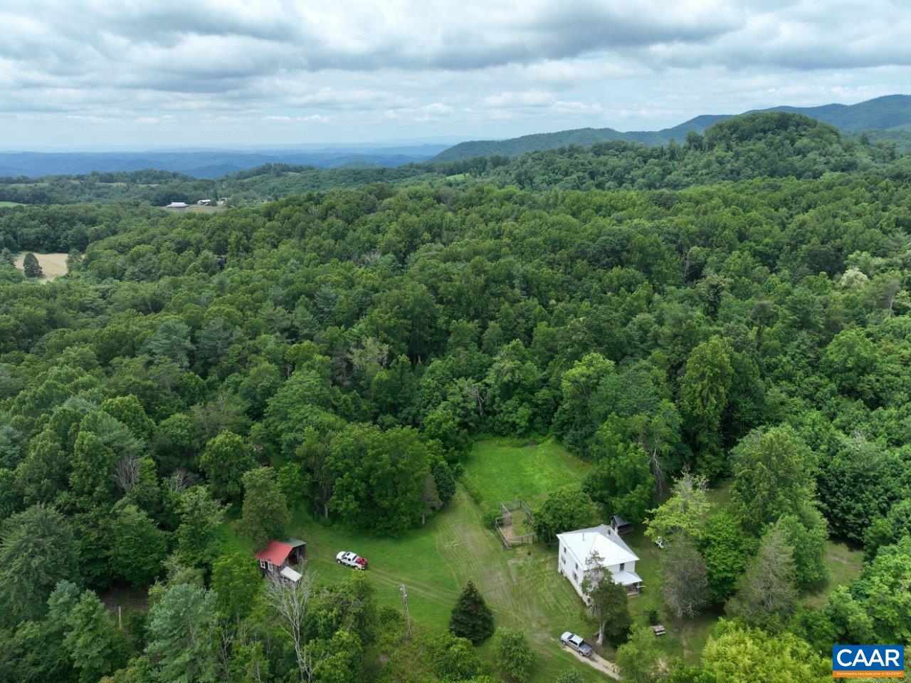 8947 Sugar Run Road Northeast Copper Hill, VA 24079 - Photo 17 of 28 a backyard of a house with lots of green space and mountains