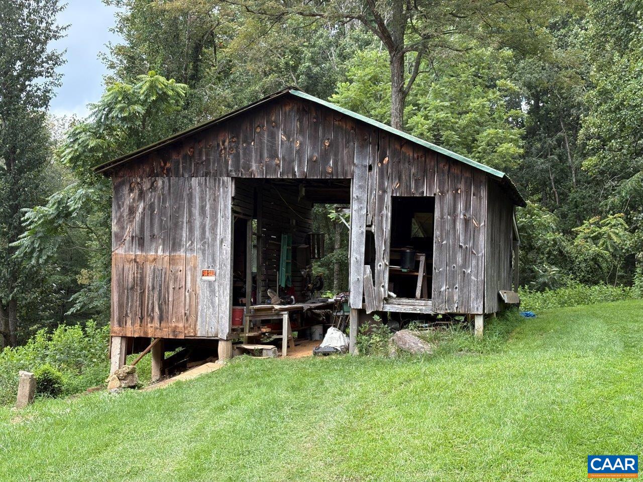 8947 Sugar Run Road Northeast Copper Hill, VA 24079 - Photo 18 of 28 a view of a small house with yard and wooden fence