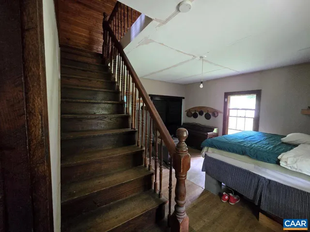 a living room with furniture and stairs