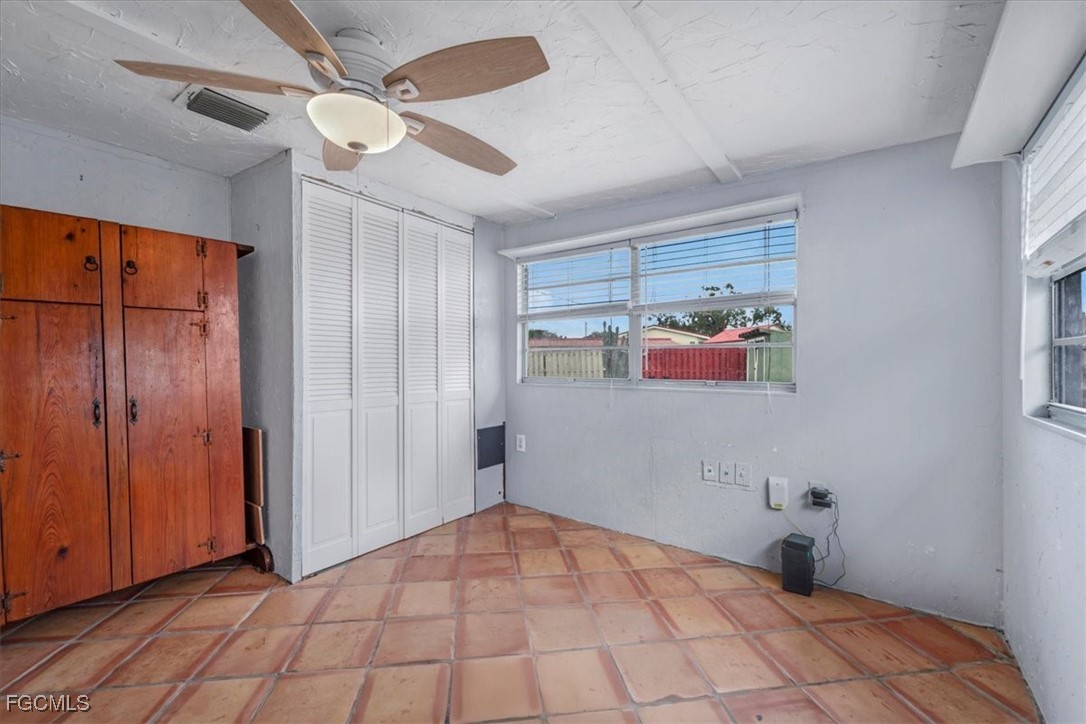 1083 Sunset Strip Moore Haven Okeechobee, FL 34974 - Photo 24 of 48 a bedroom with a bed and a chandelier