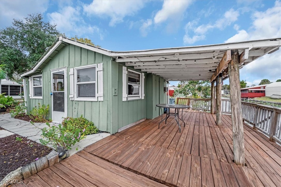 1083 Sunset Strip Moore Haven Okeechobee, FL 34974 - Photo 38 of 48 a view of backyard with a deck and wooden floor
