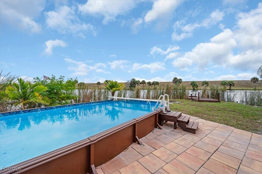 1083 Sunset Strip Moore Haven Okeechobee, FL 34974 - Photo 41 of 48 a view of a swimming pool with a lounge chairs