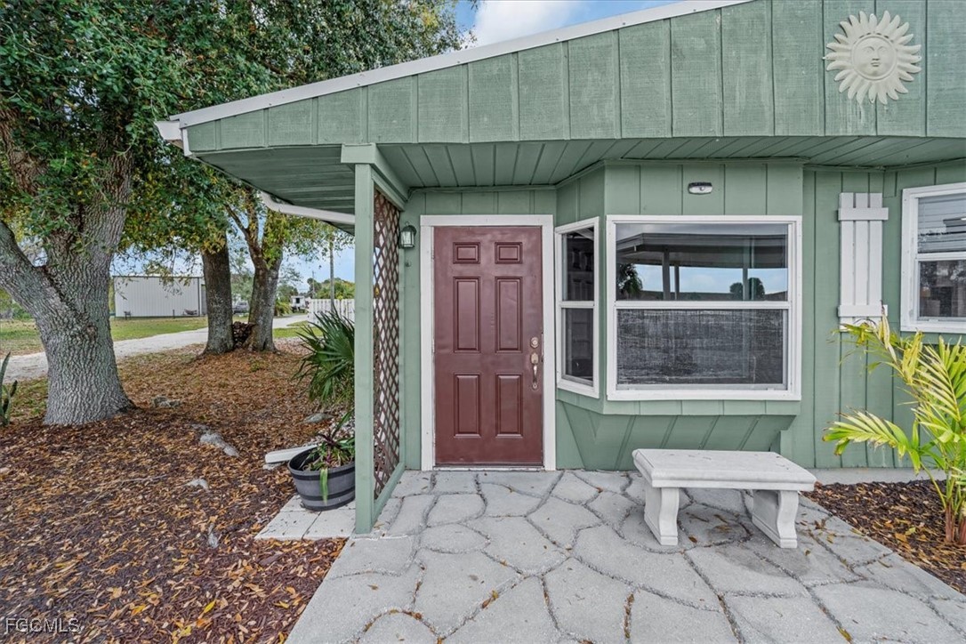 1083 Sunset Strip Moore Haven Okeechobee, FL 34974 - Photo 5 of 48 a front view of a house with a yard