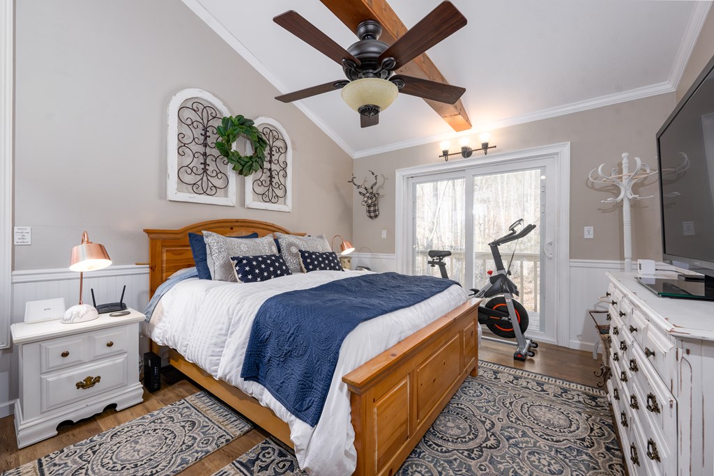 3301 Ellington Road Hayesville, NC 28904 - Photo 12 of 31 a bedroom with a bed and a chandelier