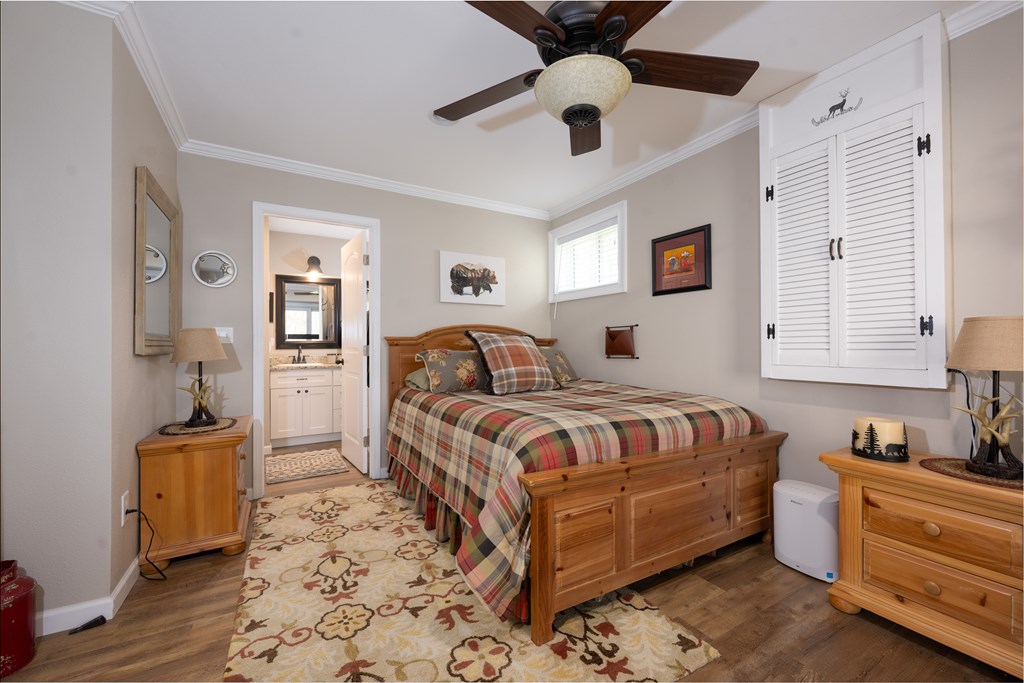 3301 Ellington Road Hayesville, NC 28904 - Photo 19 of 31 a bedroom with a bed and a chandelier