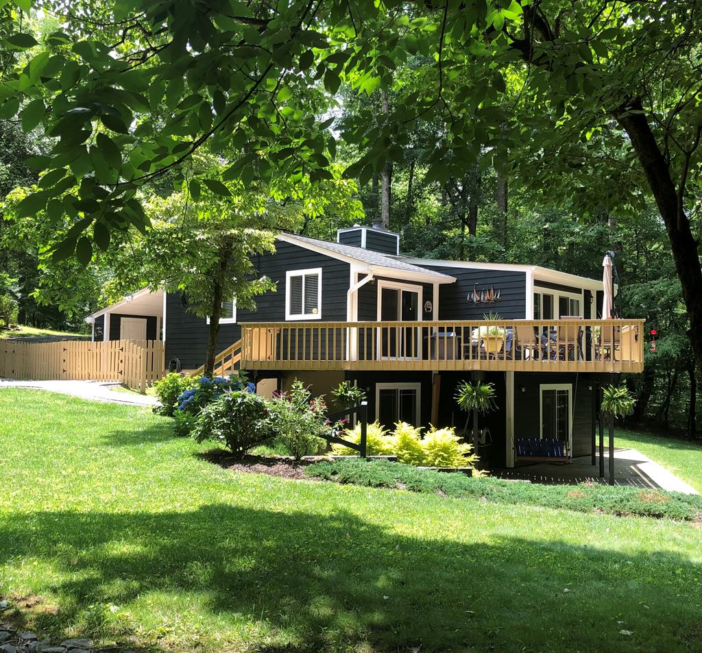 3301 Ellington Road Hayesville, NC 28904 - Photo 21 of 31 a front view of a house with a garden and yard