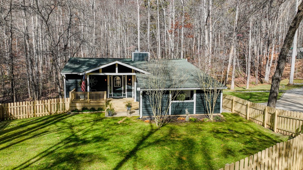 3301 Ellington Road Hayesville, NC 28904 - Photo 25 of 31 a front view of a house with a yard table and chairs