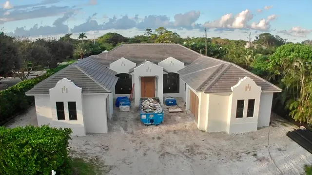 a front view of a house with patio and garden