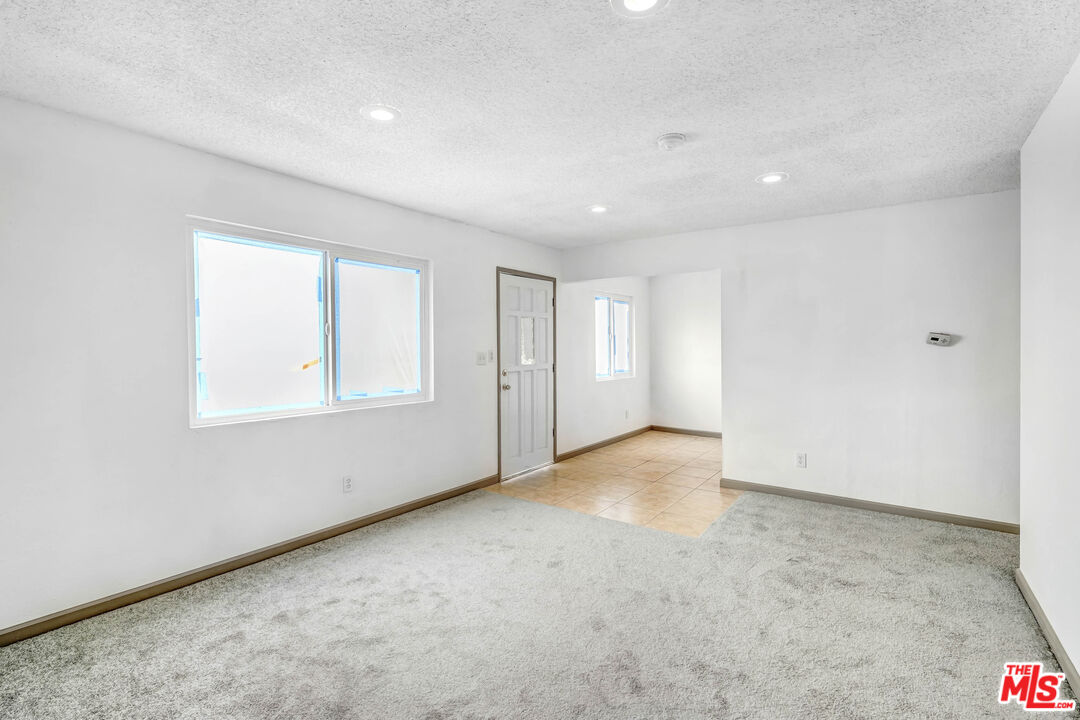 5351 Odell Street Riverside, CA 92509 - Photo 2 of 10 an empty room with windows