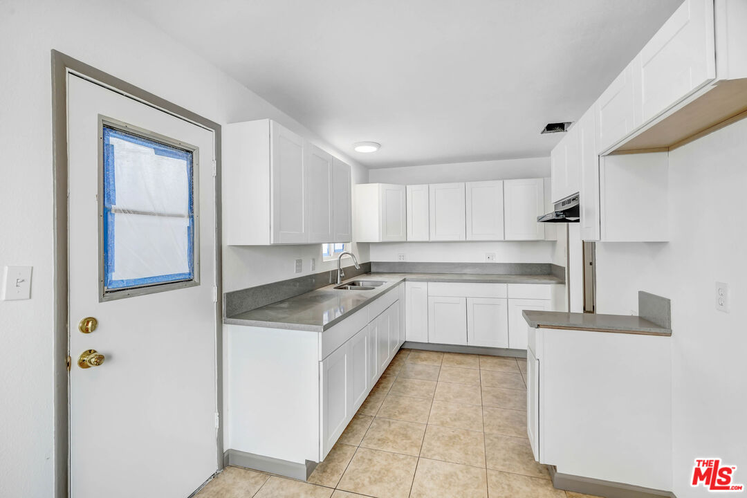5351 Odell Street Riverside, CA 92509 - Photo 3 of 10 a kitchen with stainless steel appliances granite countertop a sink and cabinets