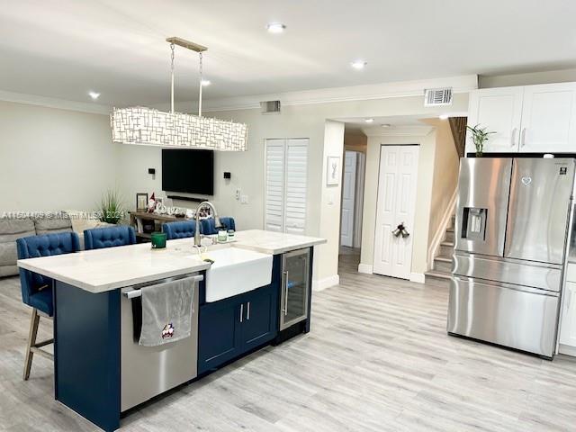 16110 Southwest 6th Street Pembroke Pines, FL 33027 - Photo 18 of 92 a kitchen with a sink stainless steel appliances a refrigerator and a fireplace
