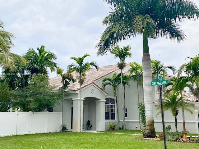 16110 Southwest 6th Street Pembroke Pines, FL 33027 - Photo 2 of 92 a front view of house with yard and green space