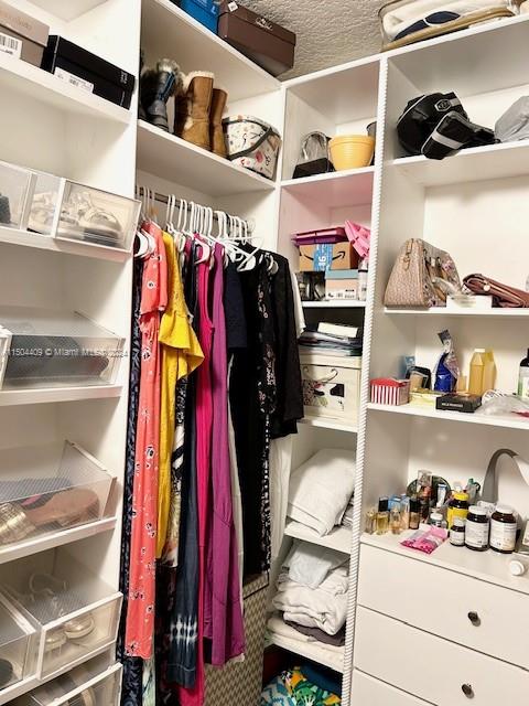 16110 Southwest 6th Street Pembroke Pines, FL 33027 - Photo 29 of 92 a view of walk in closet with clothes and shoes