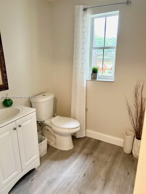 16110 Southwest 6th Street Pembroke Pines, FL 33027 - Photo 30 of 92 a white toilet sitting next to a bathroom sink