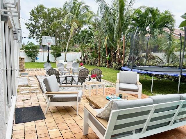 16110 Southwest 6th Street Pembroke Pines, FL 33027 - Photo 57 of 92 a view of an outdoor sitting area with furniture and garden
