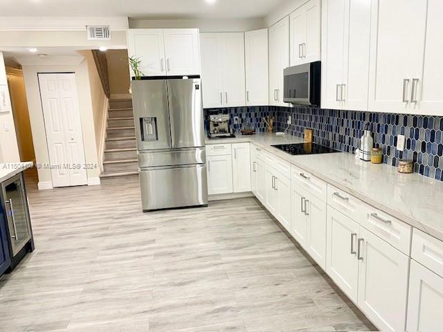 16110 Southwest 6th Street Pembroke Pines, FL 33027 - Photo 85 of 92 a kitchen with stainless steel appliances a refrigerator sink and cabinets