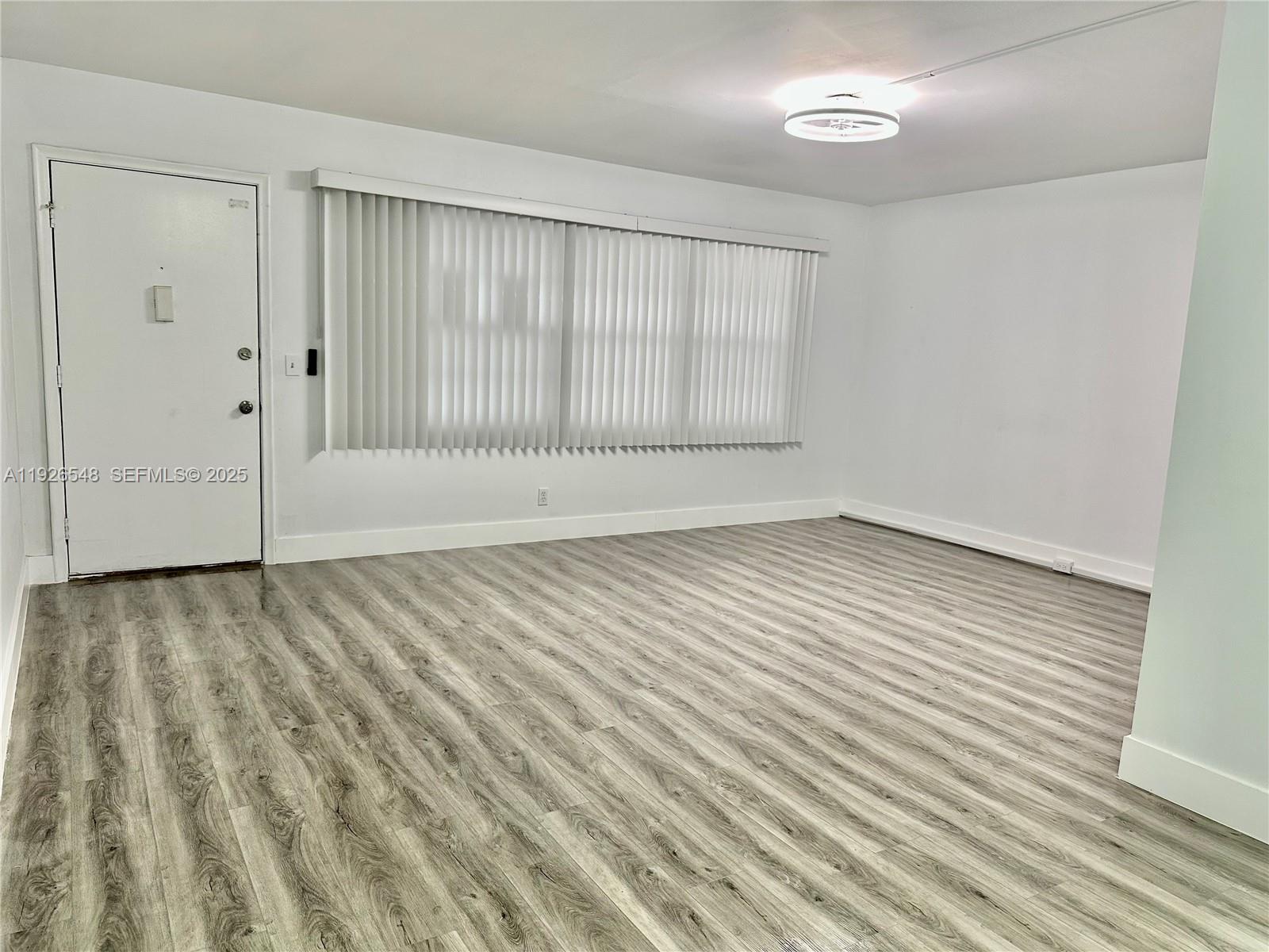 13455 Southwest 9th Court, Unit 216J Pembroke Pines, FL 33027 - Photo 11 of 66 wooden floor in an empty room
