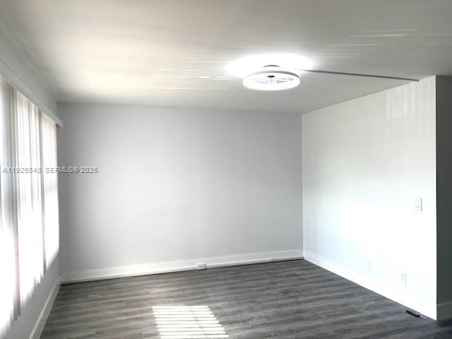 13455 Southwest 9th Court, Unit 216J Pembroke Pines, FL 33027 - Photo 16 of 66 a view of an empty room with wooden floor and a window