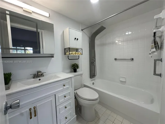 a green field with lots of trees in the background