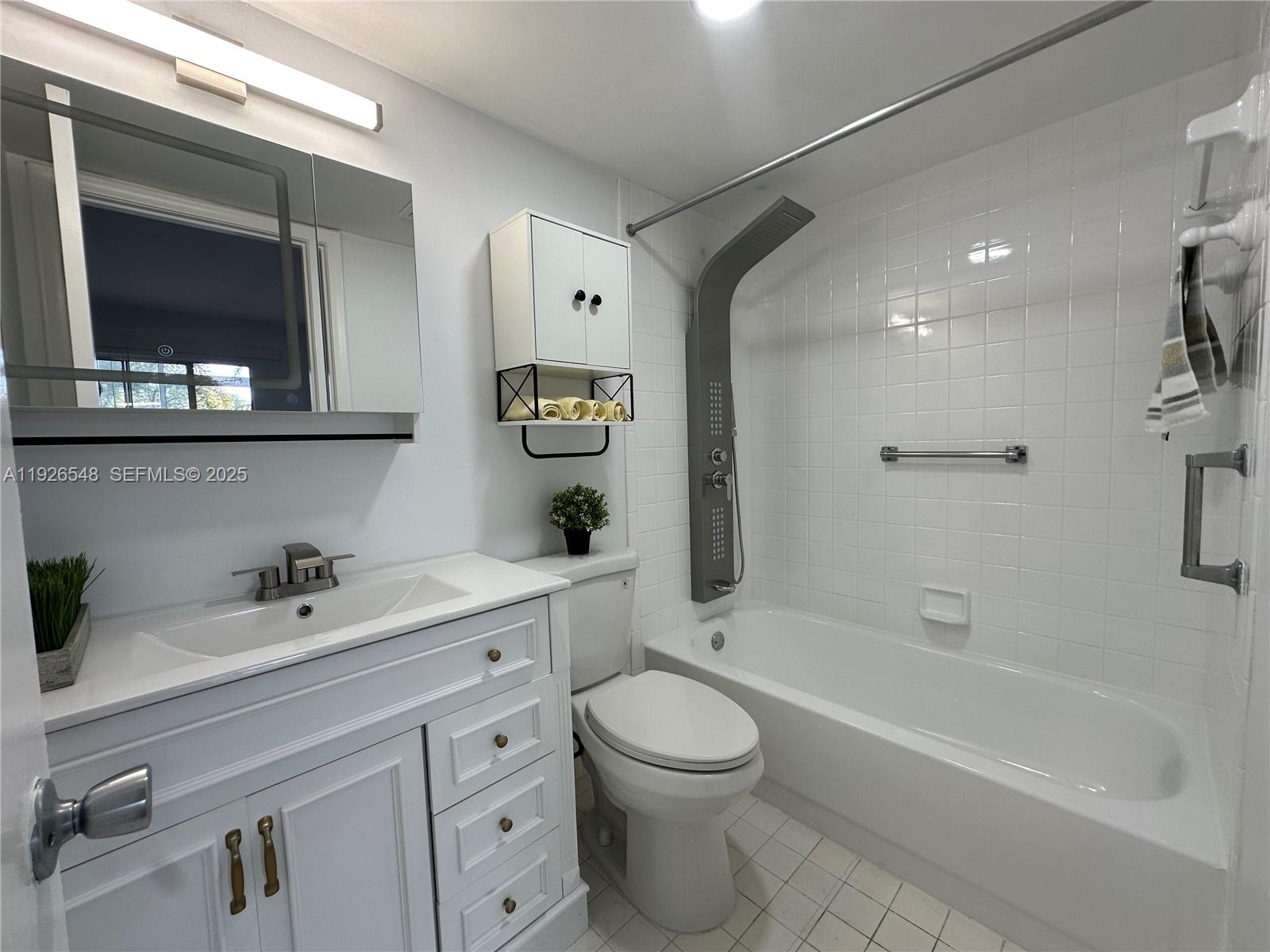 13455 Southwest 9th Court, Unit 216J Pembroke Pines, FL 33027 - Photo 17 of 66 a bathroom with a double vanity sink a toilet and shower