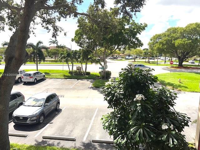 13455 Southwest 9th Court, Unit 216J Pembroke Pines, FL 33027 - Photo 21 of 66 a view of yard with swimming pool and green space