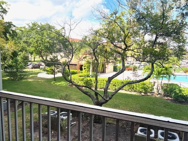 13455 Southwest 9th Court, Unit 216J Pembroke Pines, FL 33027 - Photo 24 of 66 a view of a wooden deck and a yard