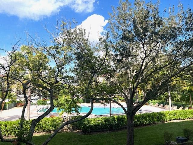 13455 Southwest 9th Court, Unit 216J Pembroke Pines, FL 33027 - Photo 26 of 66 a green field with lots of trees in the background