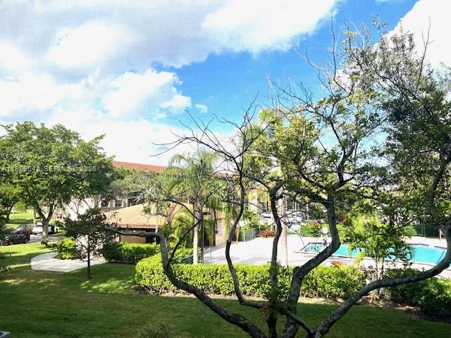 13455 Southwest 9th Court, Unit 216J Pembroke Pines, FL 33027 - Photo 27 of 66 a view of multiple houses with yard