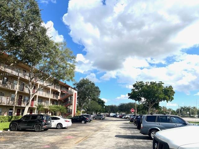 13455 Southwest 9th Court, Unit 216J Pembroke Pines, FL 33027 - Photo 31 of 66 a view of street with parked cars