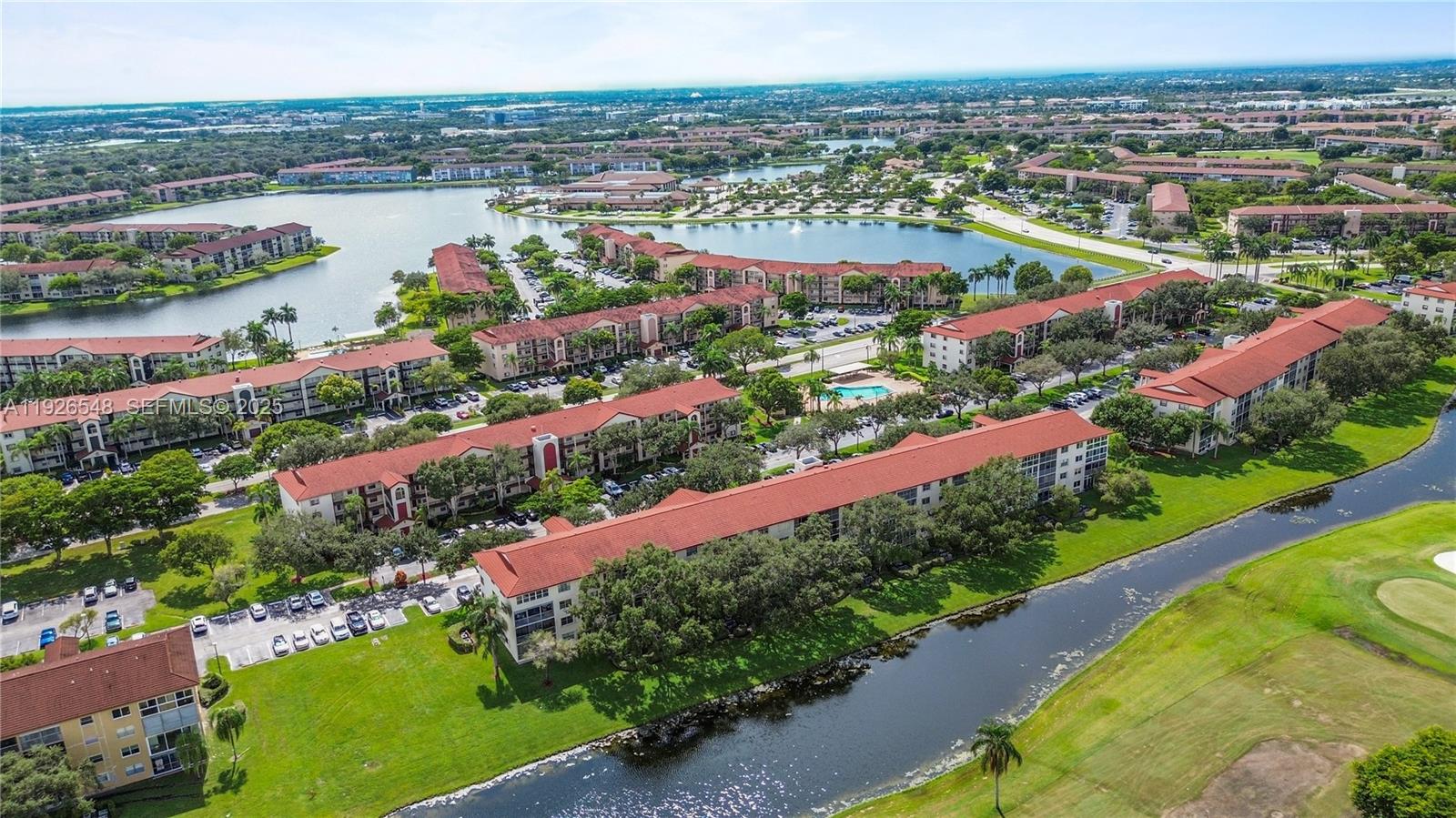 13455 Southwest 9th Court, Unit 216J Pembroke Pines, FL 33027 - Photo 36 of 66 an aerial view of lake and residential houses with outdoor space