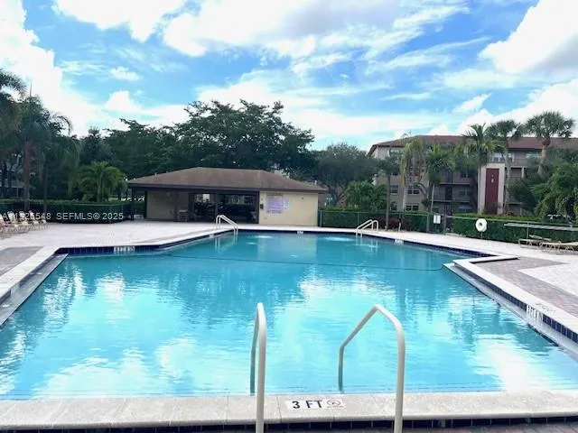 a view of a tennis ground with large trees