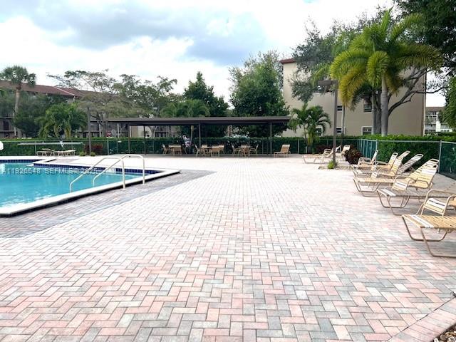 13455 Southwest 9th Court, Unit 216J Pembroke Pines, FL 33027 - Photo 42 of 66 a view of swimming pool with chairs