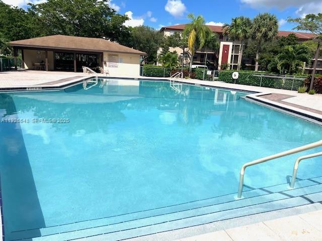 13455 Southwest 9th Court, Unit 216J Pembroke Pines, FL 33027 - Photo 46 of 66 a house view with swimming pool and sitting space